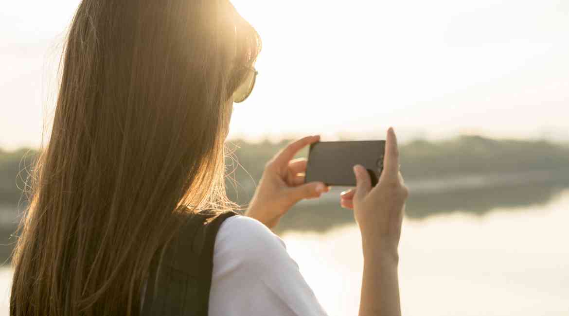 Woman With Smartphone Photographing The View While Traveling